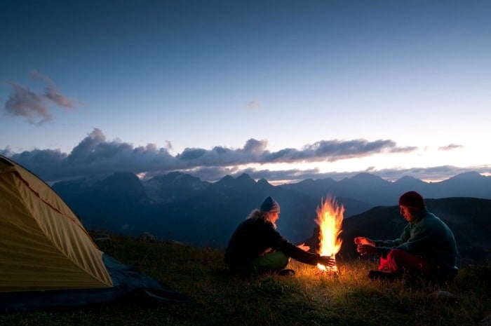 couple tent camping in the wilderness