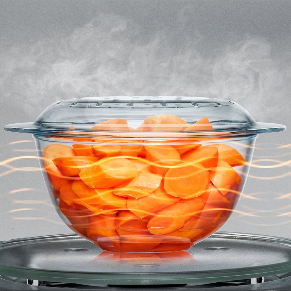 carrots cooking in a glass bowl.