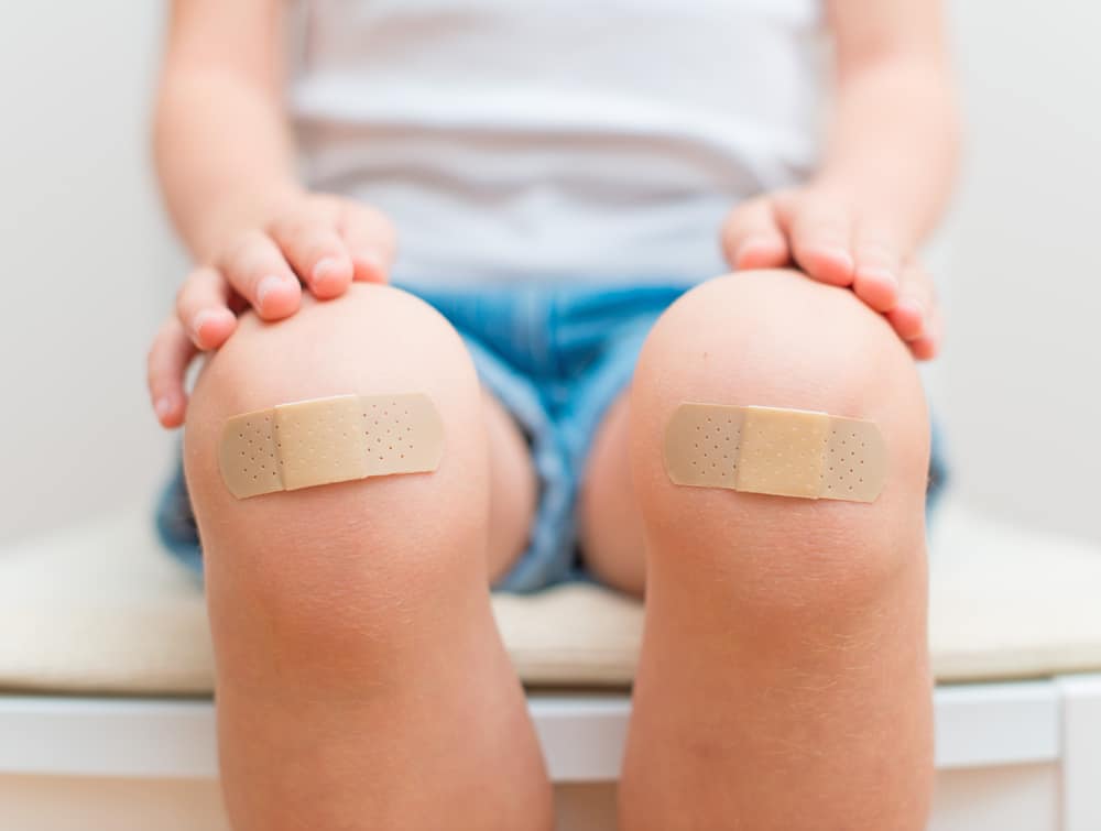 Child knees with bandage Optum Perks review