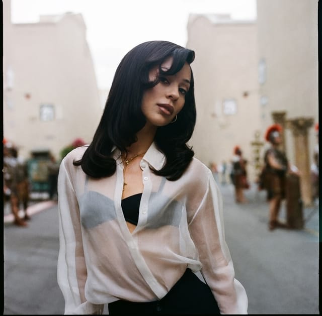 Teen girl standing alone in an urban street scene, reflecting the intense emotional tone of the TV series Euphoria.