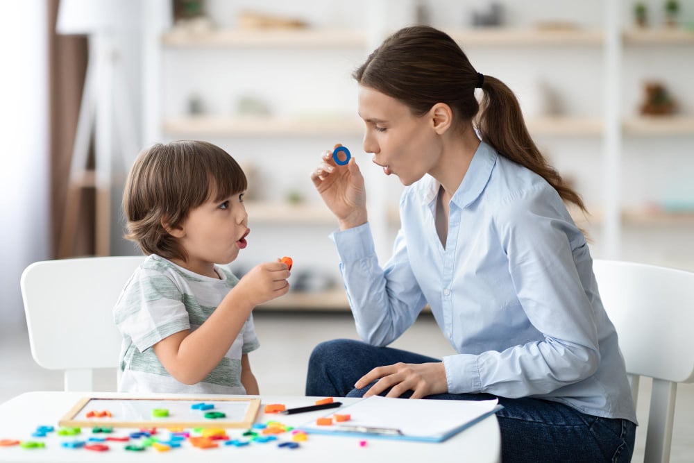 speech therapist curing childs problems and impediments little boy learning letter o