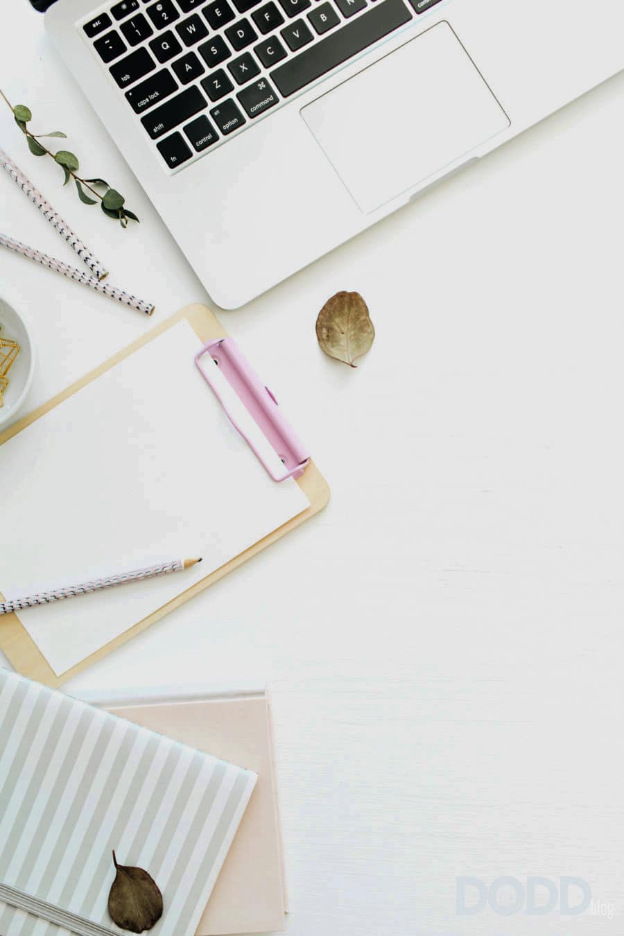 Flat lay home office desk workspace with laptop, notebook and clipboard on white background. Top view minimal mock up template.