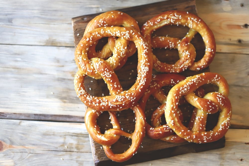 Fresh homemade pretzels on a wooden surface.