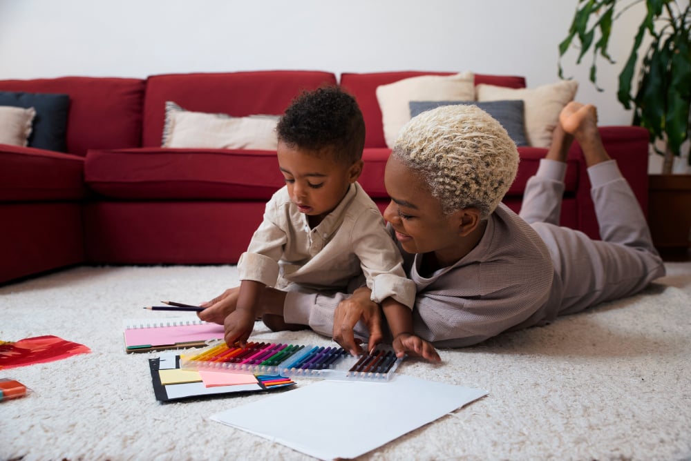 mother and son drawing on the floor