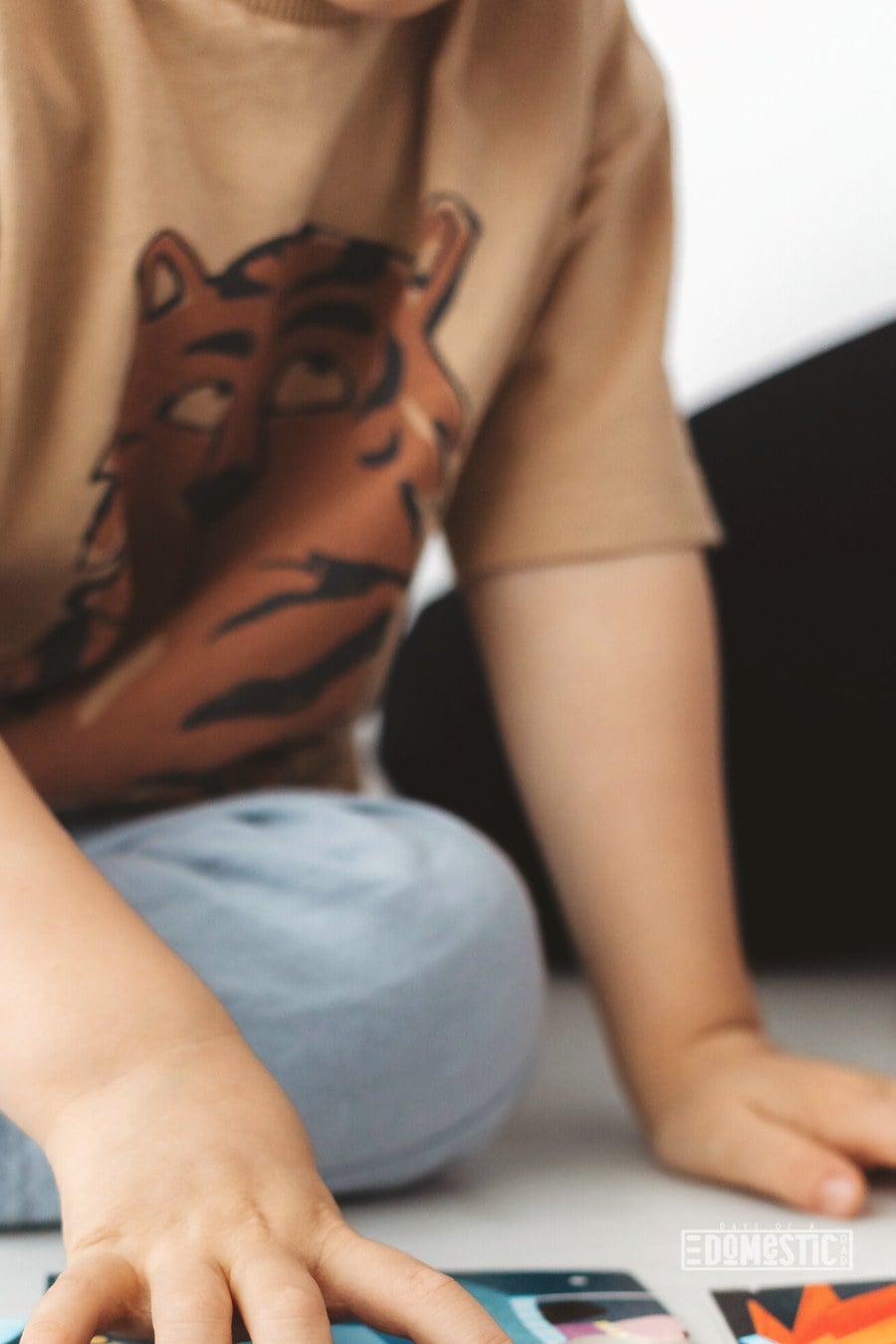 young boy playing with space themed cards