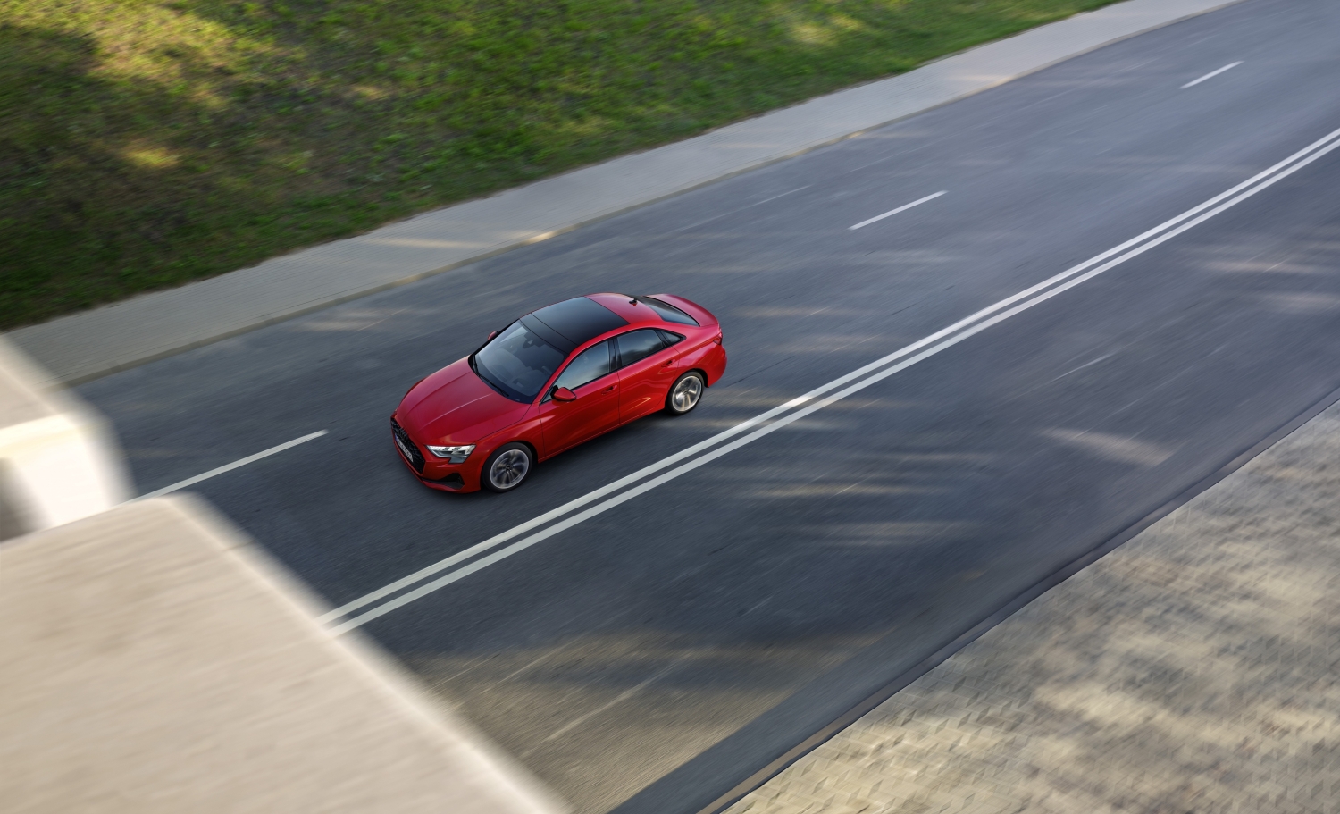 2025 Audi A3 red sedan driving on a city road, overhead view