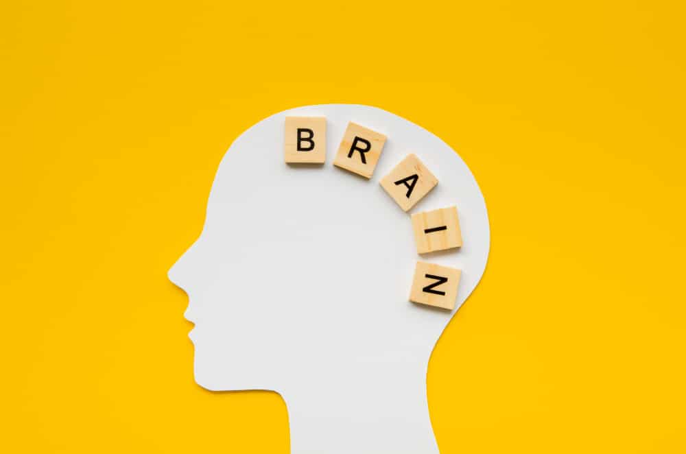 White head with brain word from scrabbles letters