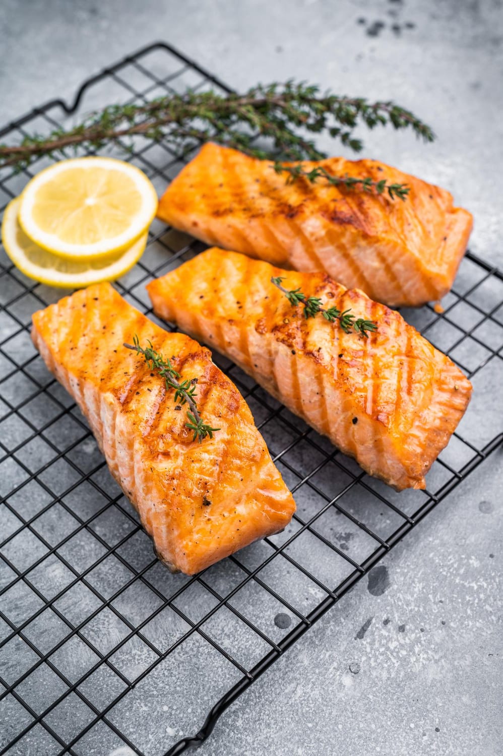 Grilled salmon fillets showing flaky texture at the ideal internal temperature of 130°F for juicy salmon