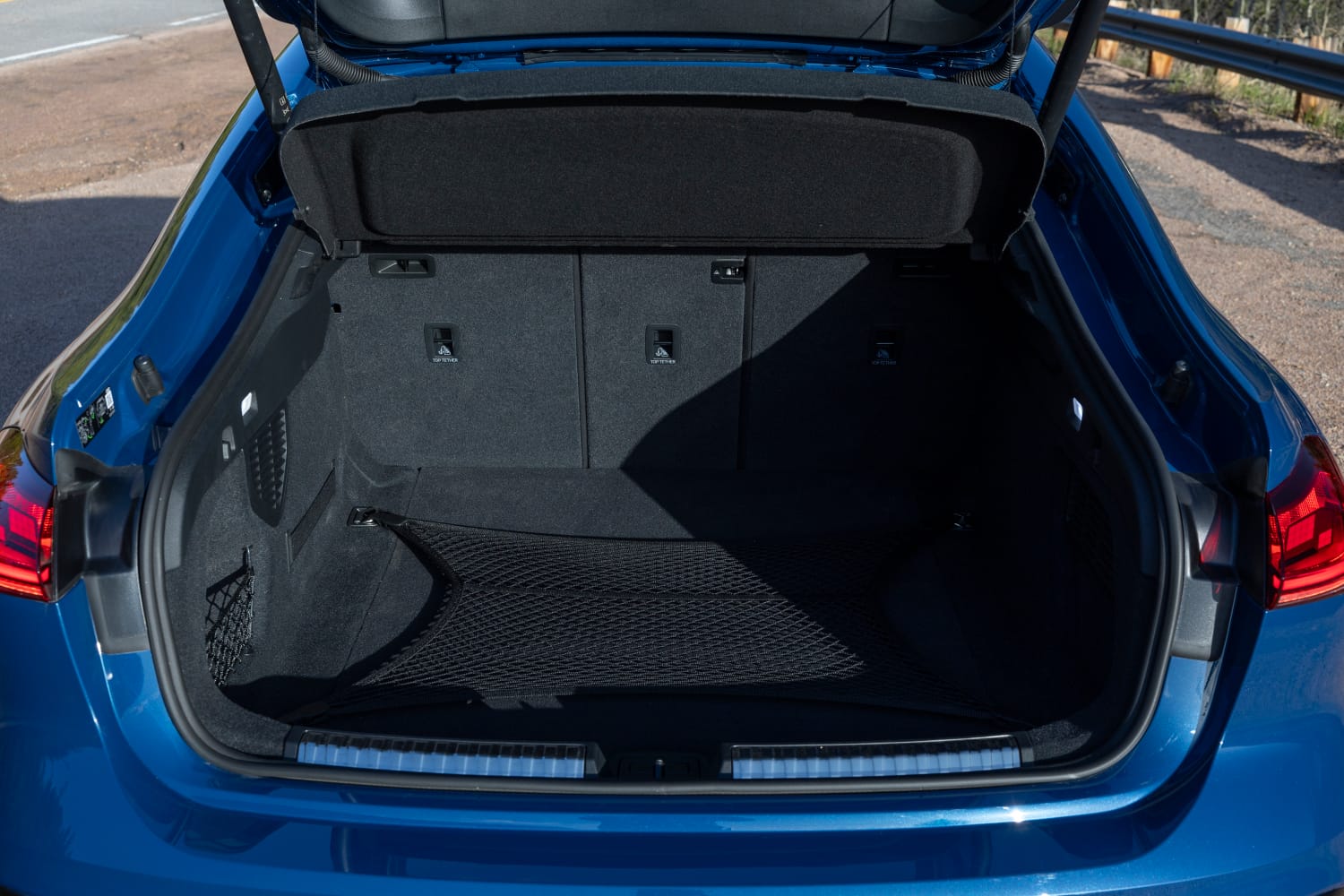 The 2026 Audi S5 with the rear liftback open, demonstrating how the hatchback design makes loading family gear easier.
