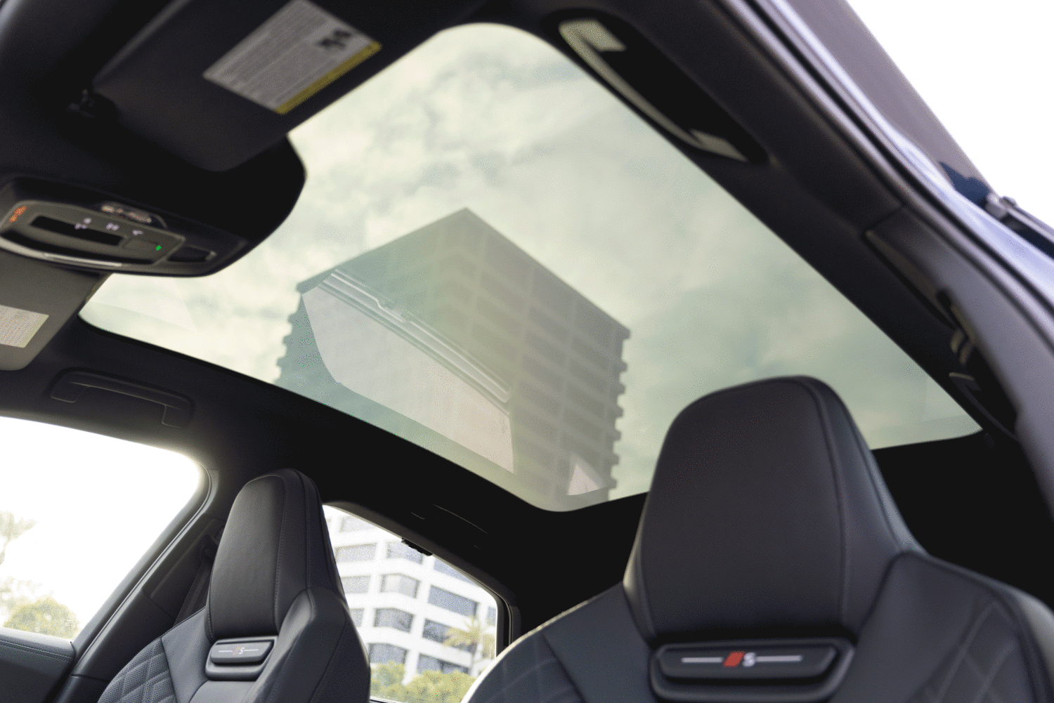 Looking up through the panoramic glass roof of the 2026 Audi S5, showing the variable light control feature.