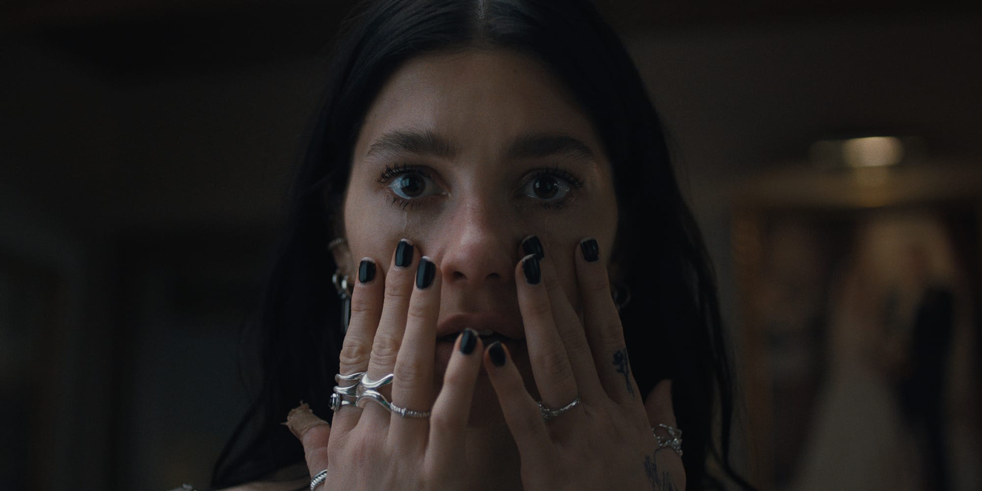 Intense close-up scene from Something Very Bad Is Gonna Happen on Netflix, premiering March 27, 2026.
