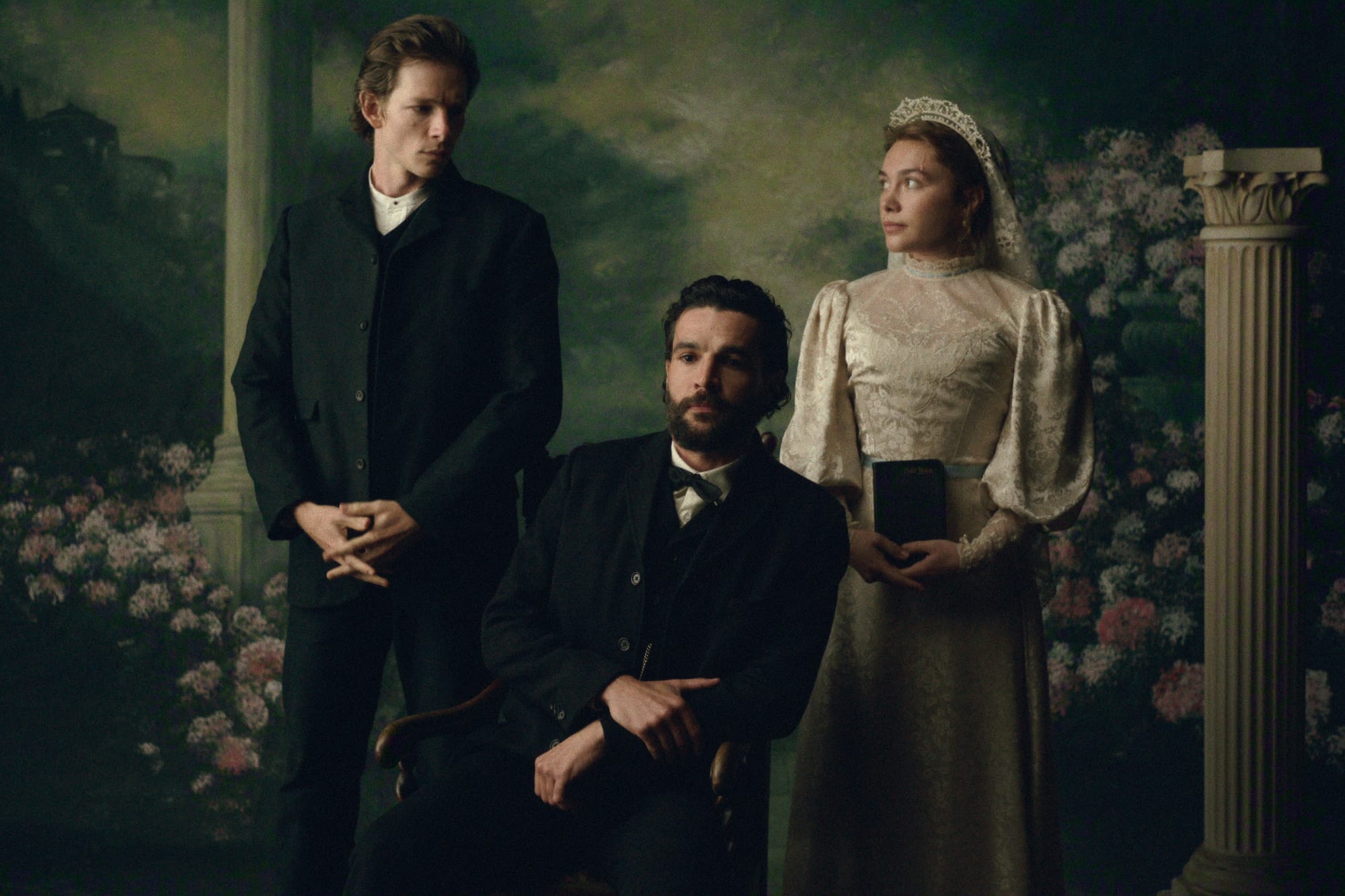 Two men in dark suits and a woman in a wedding dress pose for a portrait in East of Eden.