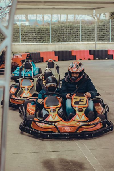 A Man and Child Driving a Go Kart