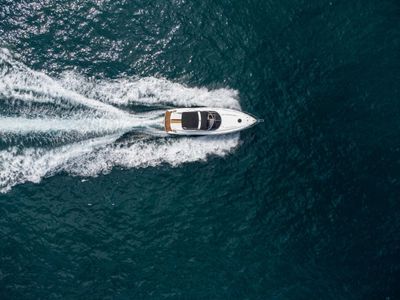 Photo aerial view of speed motor boat on open blue sea