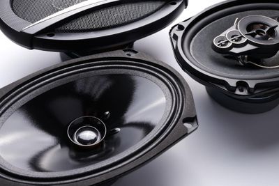Photo black car sound speakers closeup on a white background audio system hard bass subwoofer