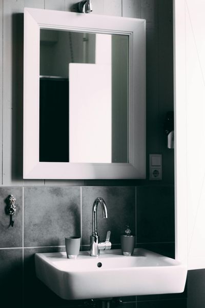 Contemporary bathroom showcasing a sleek sink and framed mirror, perfect for modern interior designs.