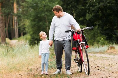 Front view father and daughter walking