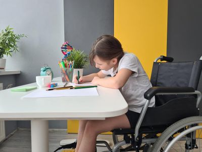 Girl schoolgirl with homework in class at school