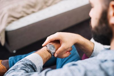 Free photo man checking time on wrist watch