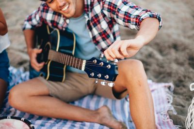 Man with guitar at the beach