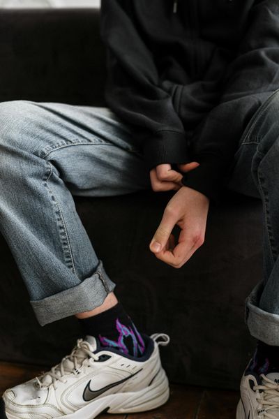 Person in Black Blazer and Blue Denim Jeans