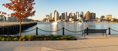 View across boston harbor to the boat traffic fronting the downtown city skyline