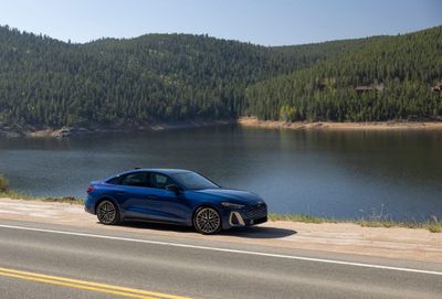 A front three-quarter view of the 2026 Audi S5 in a metallic finish, showing off its new athletic stance and wider grille.