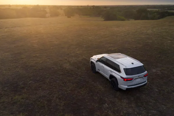White 2025 Toyota Sequoia 1794 edition parked on an open landscape, showcasing its rugged full-size SUV design and panoramic