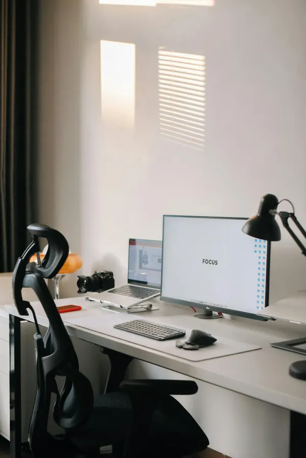 A clean and minimalist home office setup with a focus on productivity and modern technology.