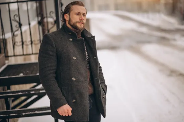 Bearded man posing in the street in winter