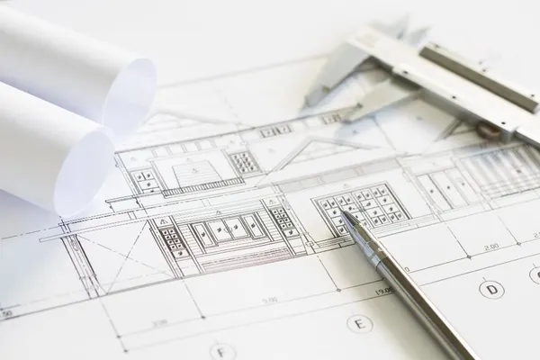 construction plans and drawing tools on blueprints