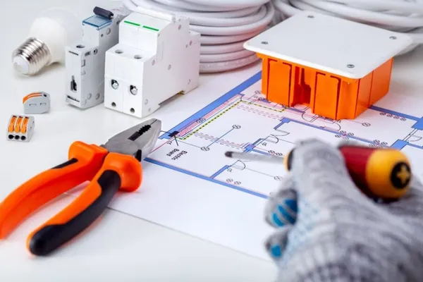 Electrician working with electrical scheme