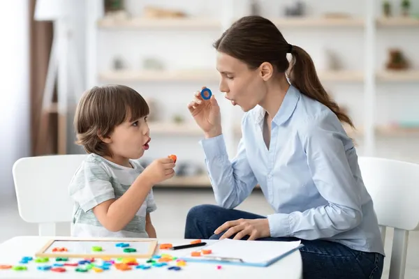 speech therapist curing childs problems and impediments little boy learning letter o