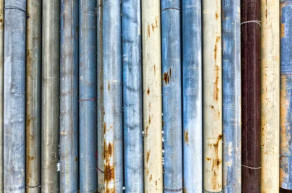 Wall with various thick shabby pipes