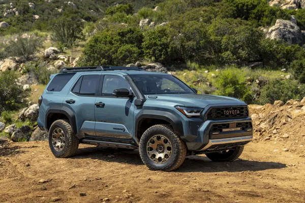 A 2025 Toyota 4Runner Trailhunter in Everest green tackling a rocky trail, showcasing its 10.1-inch ground clearance and Old Man Emu suspension.