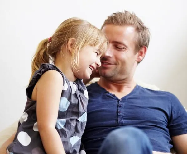 dad and daughter laughing together during summer family time creating happy memories