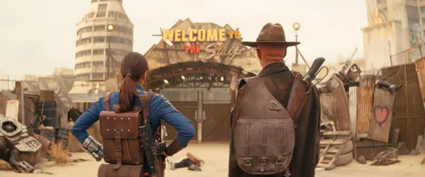 Fallout parents guide scene showing Lucy and the Ghoul approaching the Strip in the post-apocalyptic wasteland
