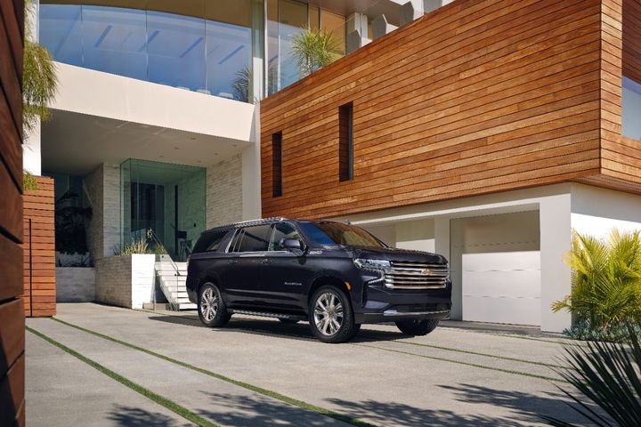 The 2023 Suburban High Country front three-quarter view parked.