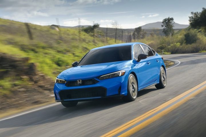 2025 Honda Civic Hatchback Sport Touring Hybrid on a desert road during the day