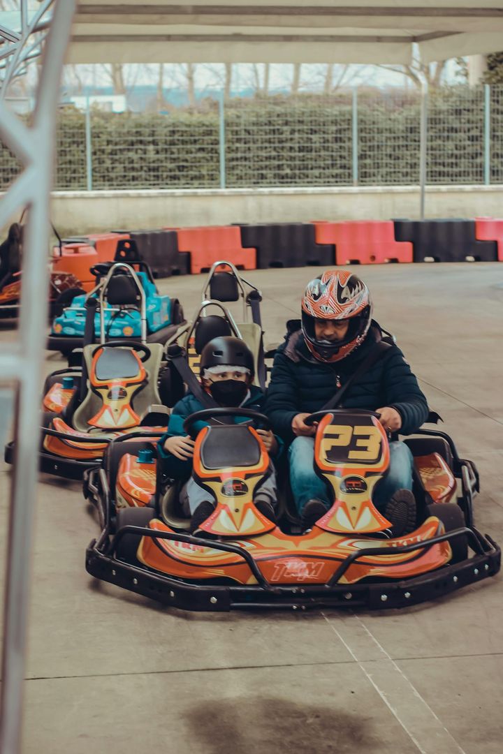 A Man and Child Driving a Go Kart