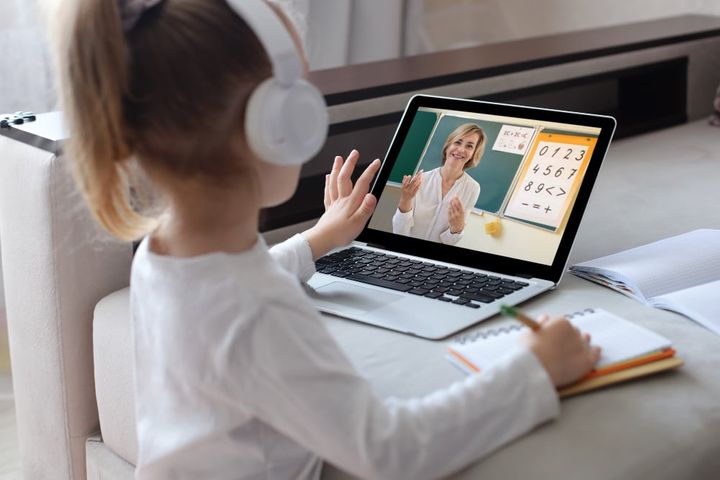 Photo cheerful girl using laptop computer studying through online elearning system