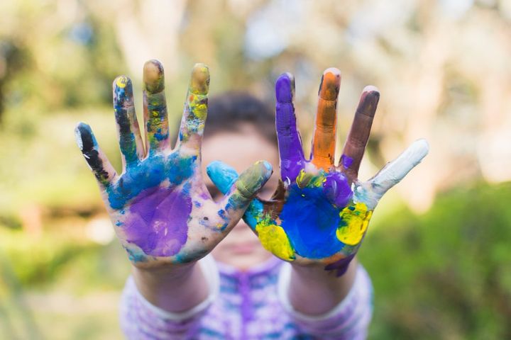 Close-up of a girl showing painted hands