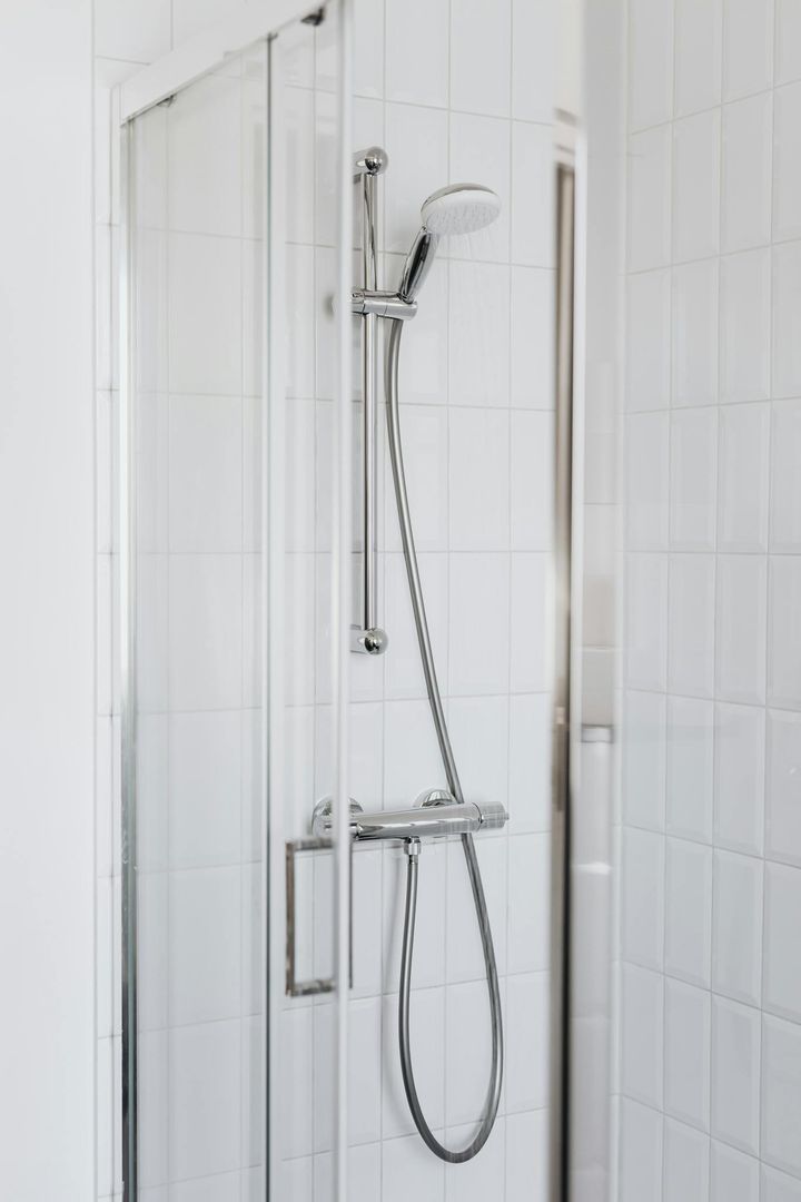 white bathroom with clear shower door. This blog post is about upgrading your shower door and bathroom.