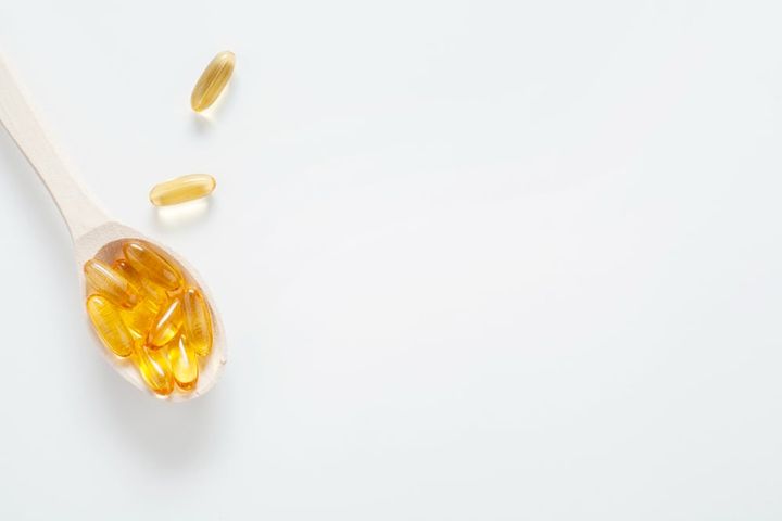 Fish oil capsules on a spoon