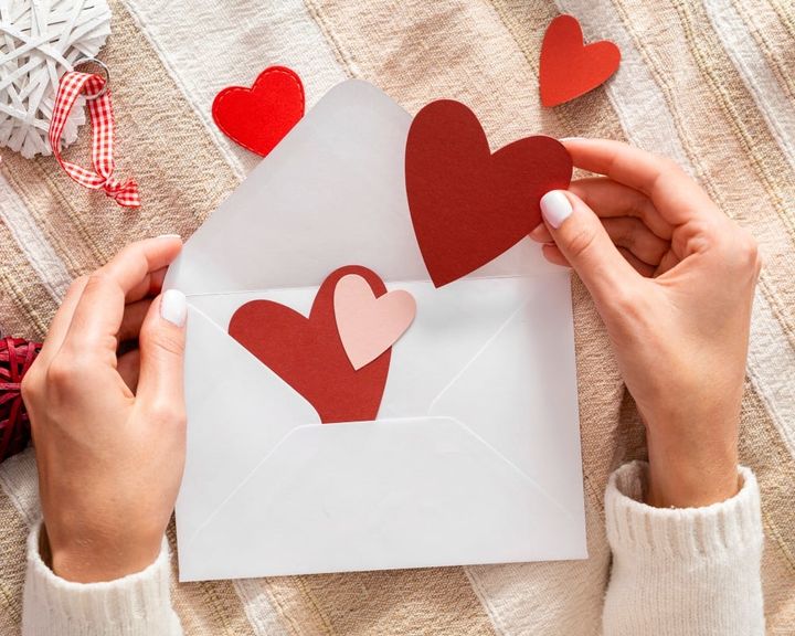 Young lady hand holding valentine envelop