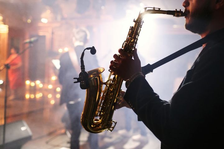 man plays on a saxophone