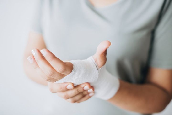 woman with gauze bandage wrapped around her hand