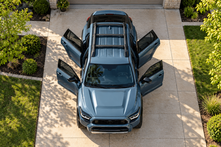 Top view of an SUV with all four doors open in a residential driveway