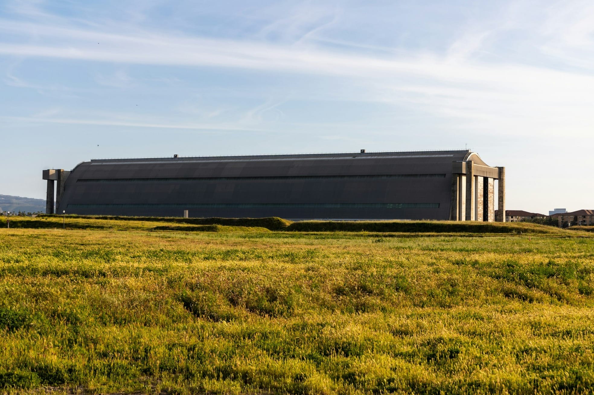 a large building sitting on top of a lush green field