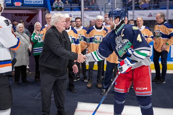 Hartford Wolf Pack captain Casey Fitzgerald shakes hands with former Hartford Whalers owner Howard Baldwin, 1/11/25.